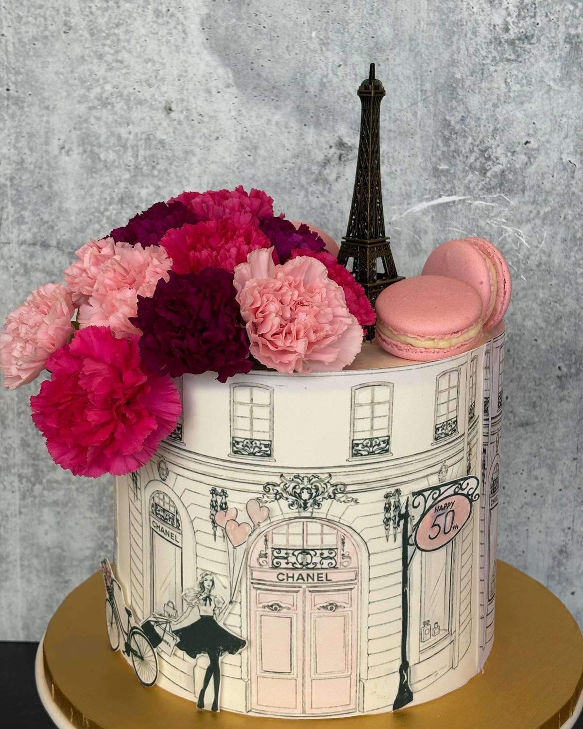 Paris-themed 50th birthday cake with Chanel design, Eiffel Tower and macarons